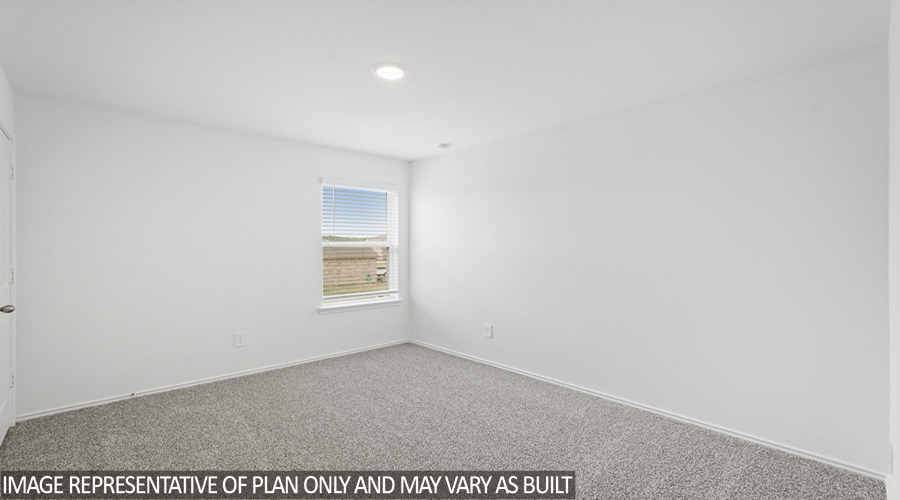 Secondary bedroom with soft carpet flooring.