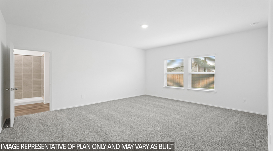 Primary bedroom with two bright windows.