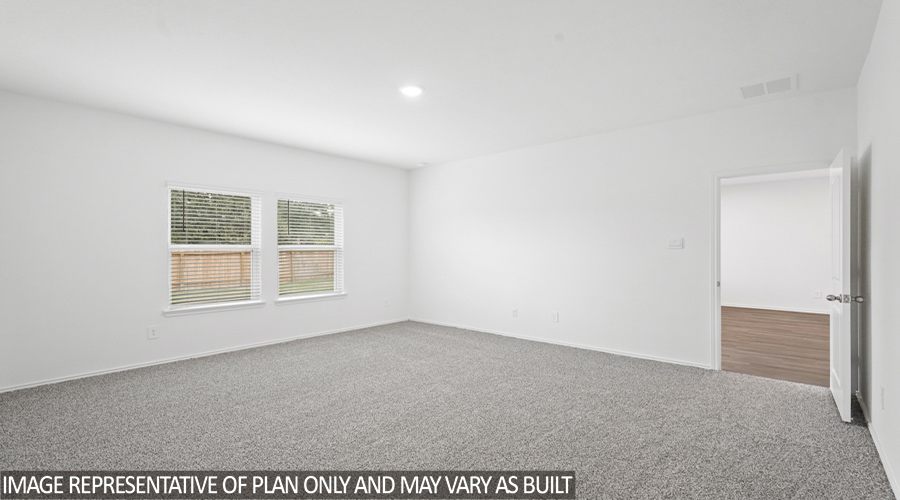 Primary bedroom with carpet flooring.