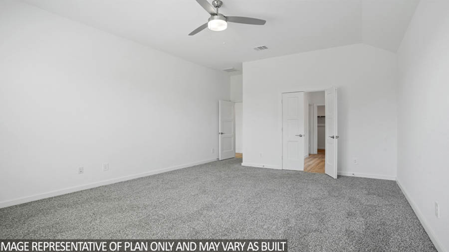Primary bedroom with carpet flooring