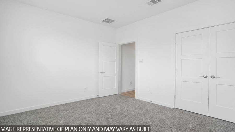 Secondary bedroom with carpet flooring