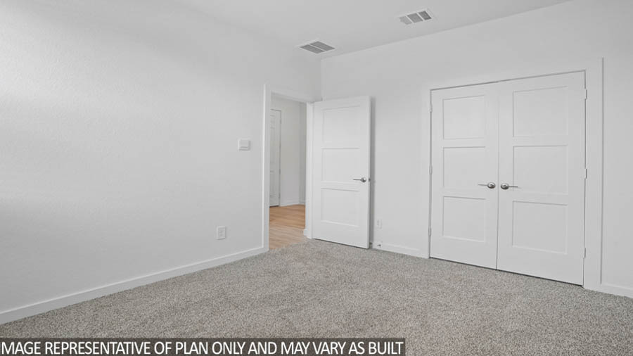Secondary bedroom with carpet flooring