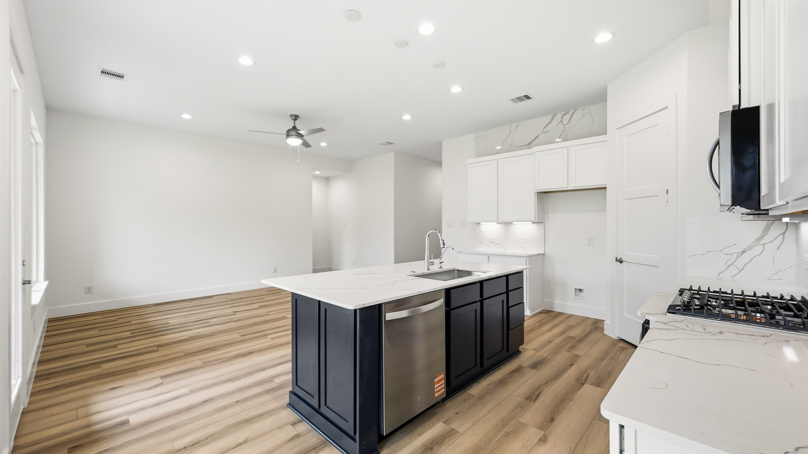 Spacious living area with vinyl flooring