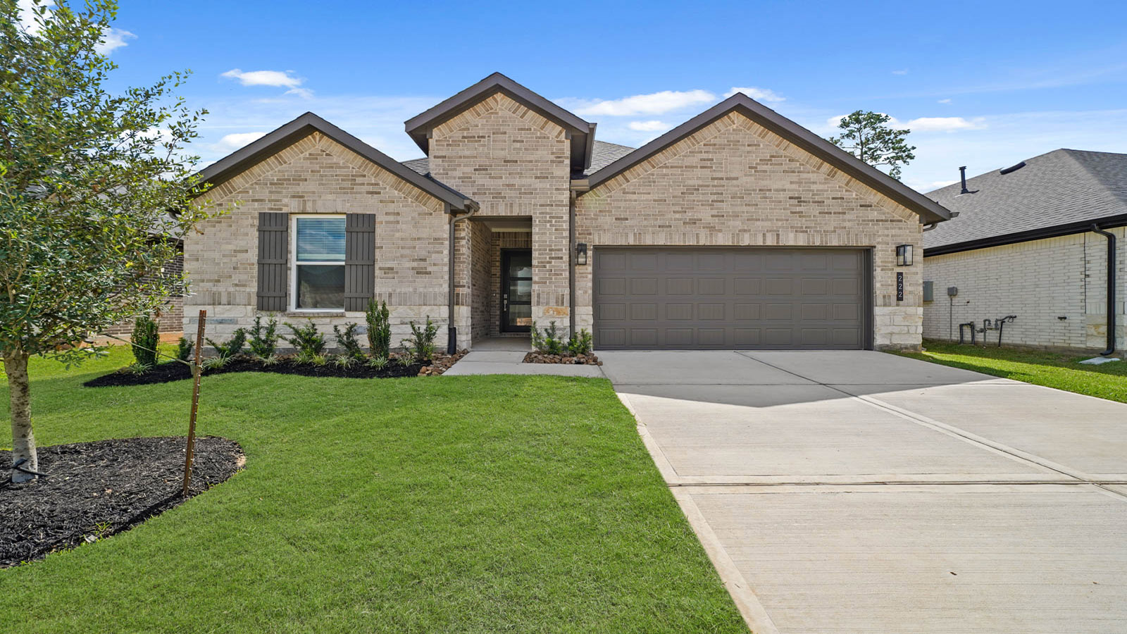 Front of the one-story home with brick.