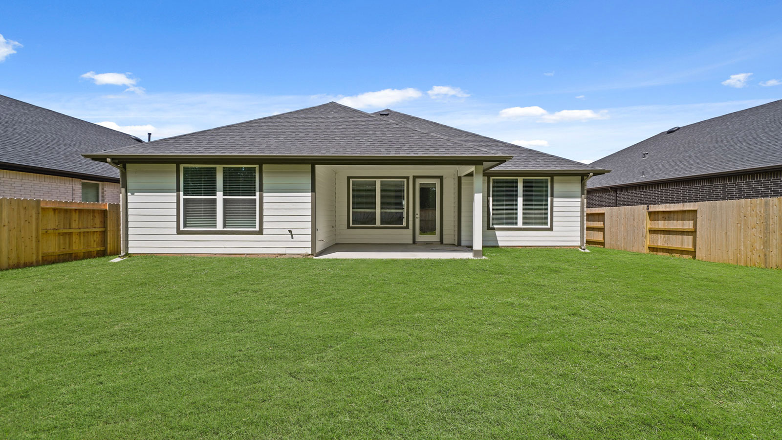 Landscaped backyard with a covered patio.