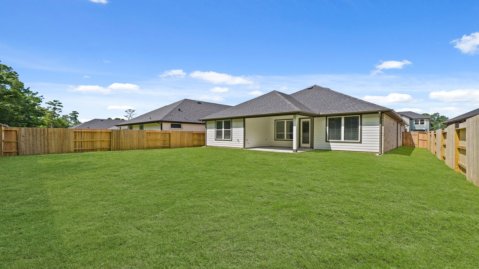 Landscaped backyard with a covered patio.