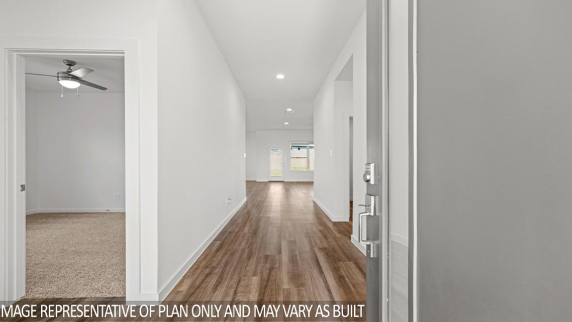 Entry hallway with white walls and vinyl wood flooring.