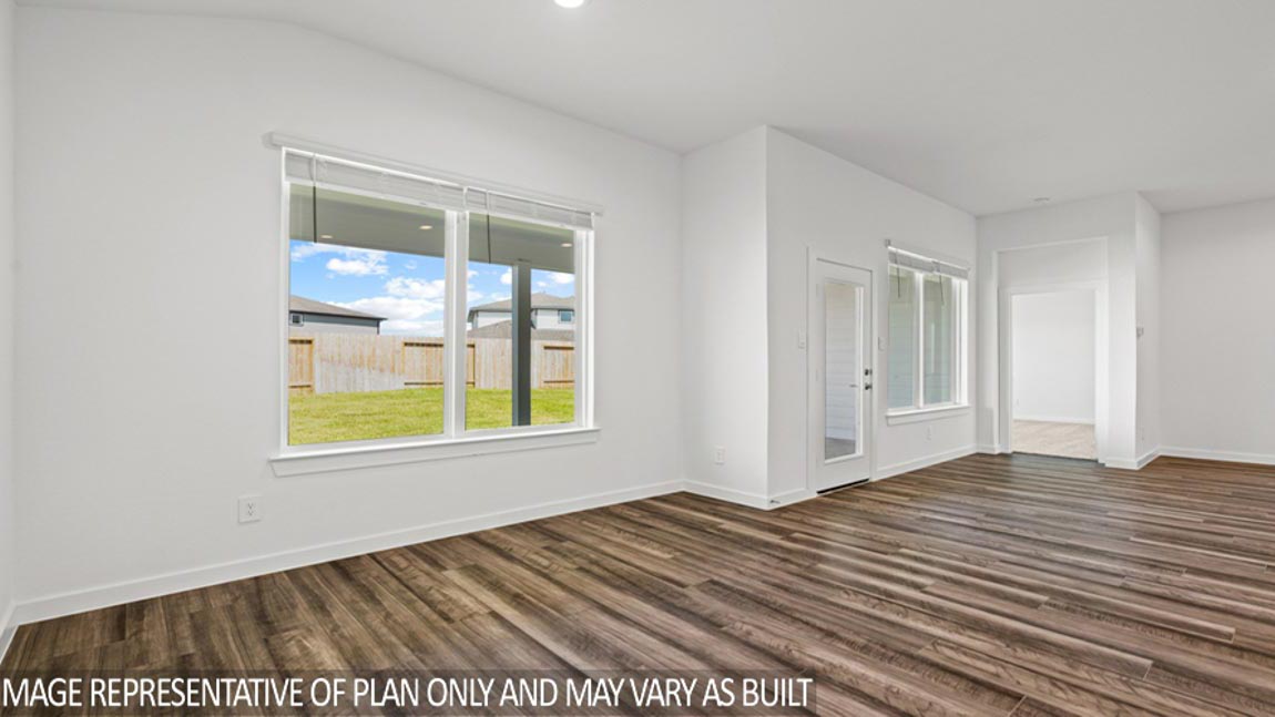 Open living room with windows, white walls, and vinyl wood flooring.