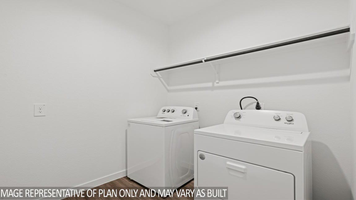 Laundry room with white walls and vinyl wood flooring.