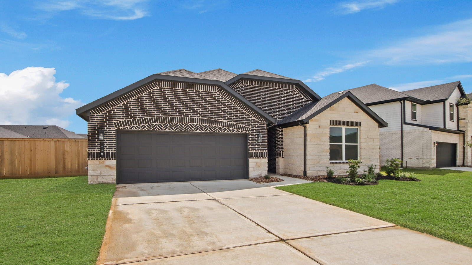 Front of the home with brick.