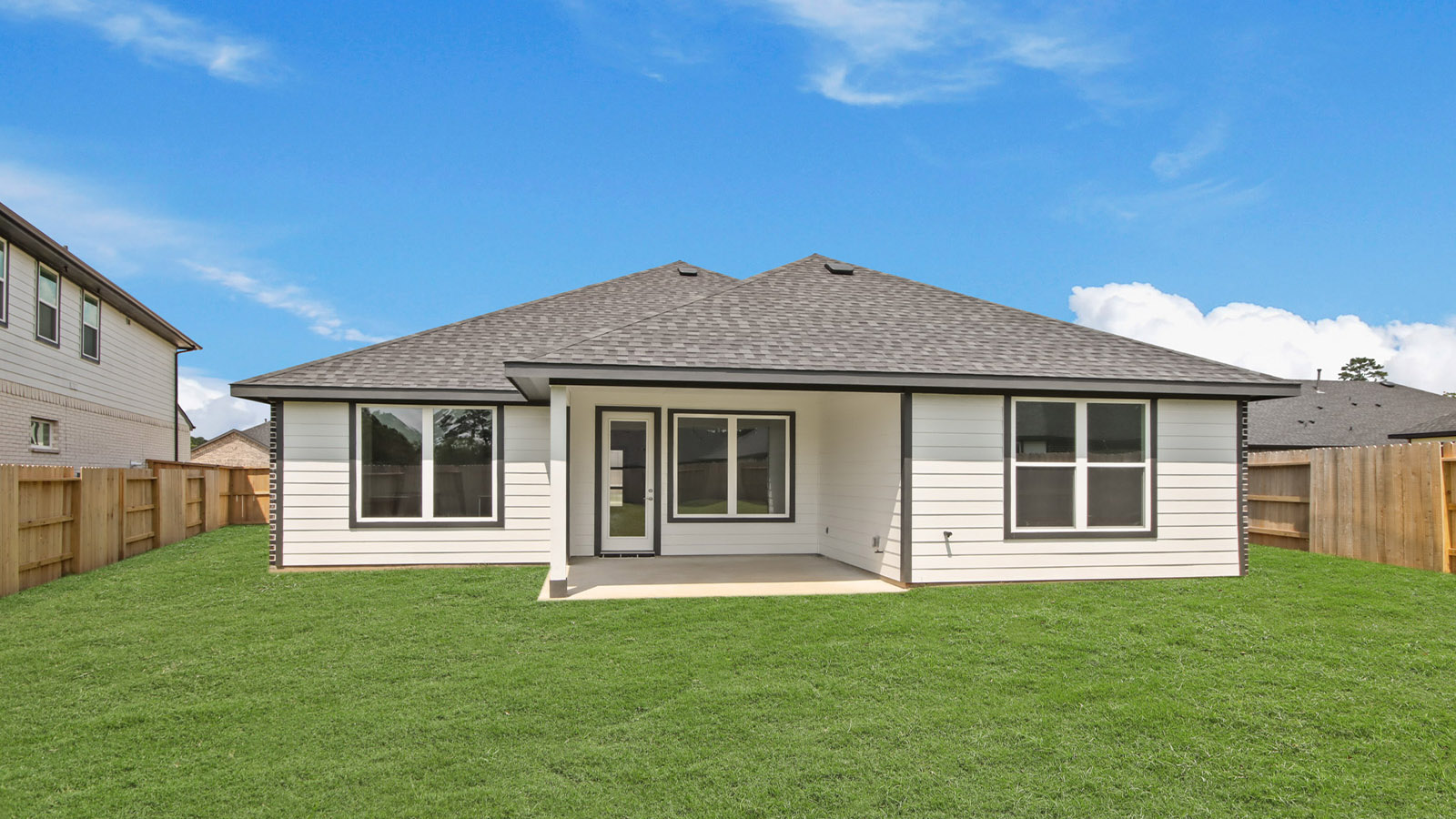 Landscaped backyard with a covered patio.