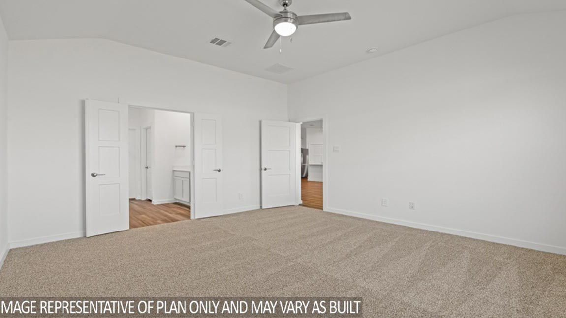 Primary bedroom with carpet flooring
