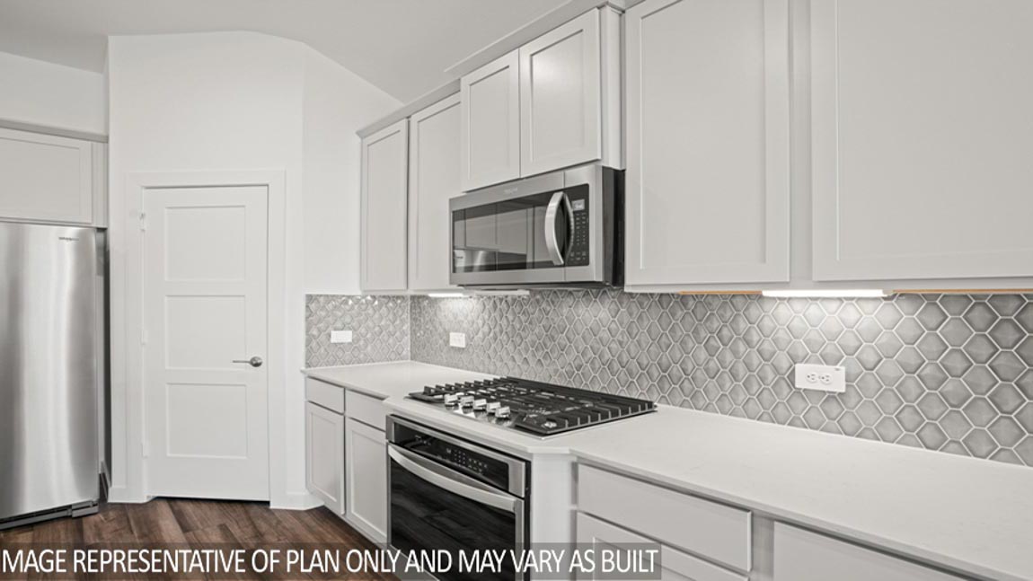 Kitchen with an island and stainless-steel appliances.