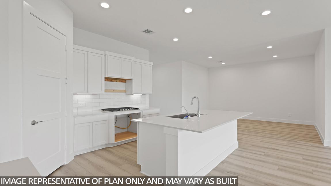 Kitchen with an island and vinyl floor