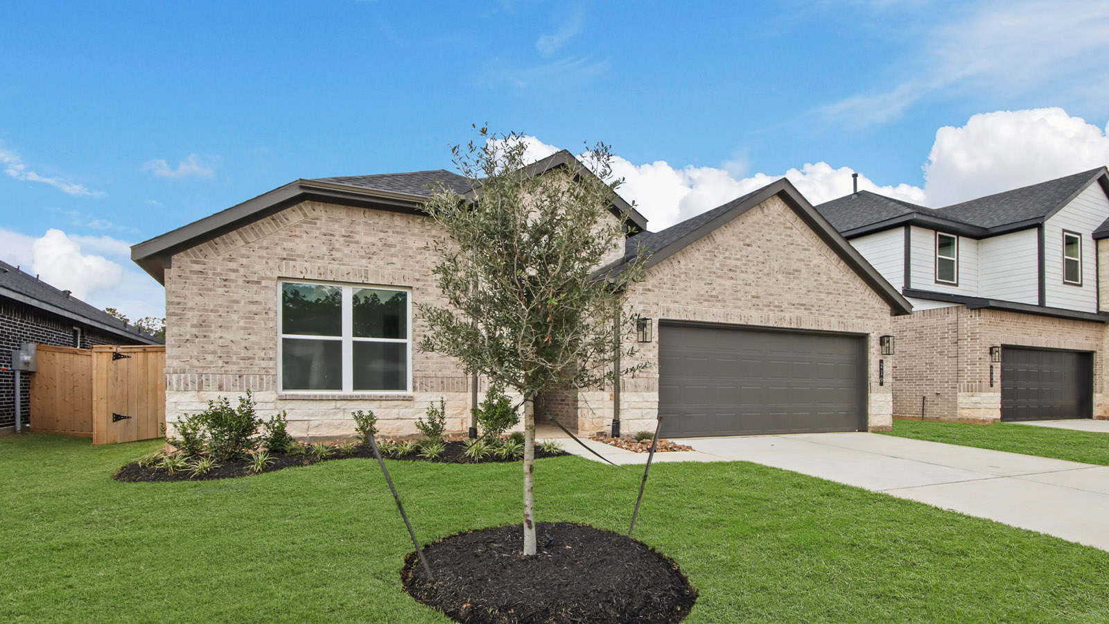 Front of the home with brick.