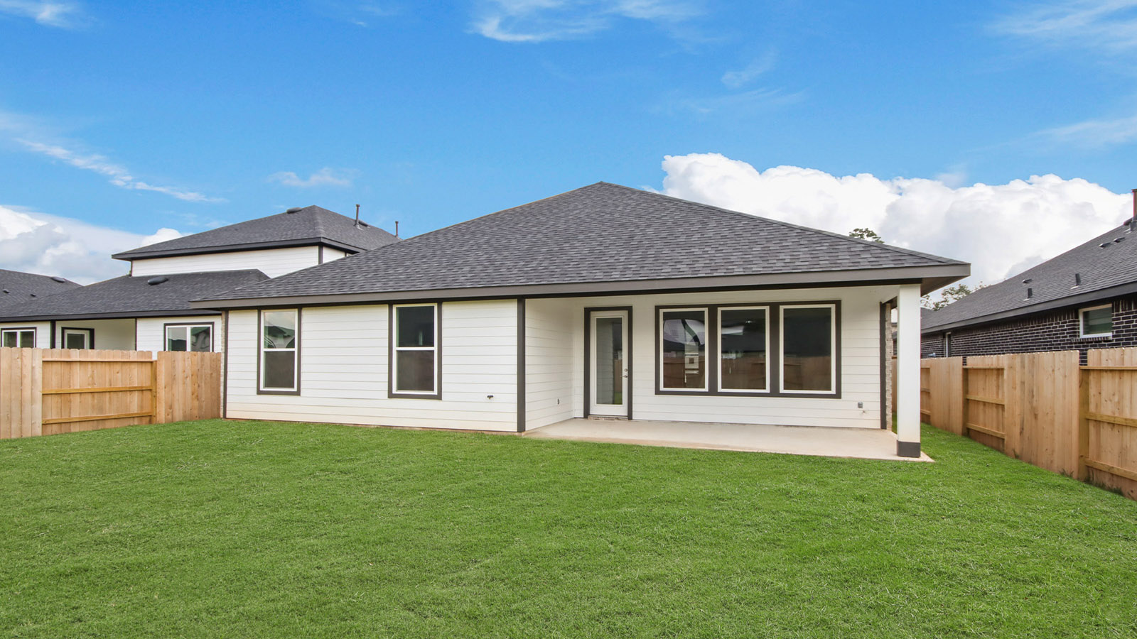 Landscaped backyard with a covered patio.