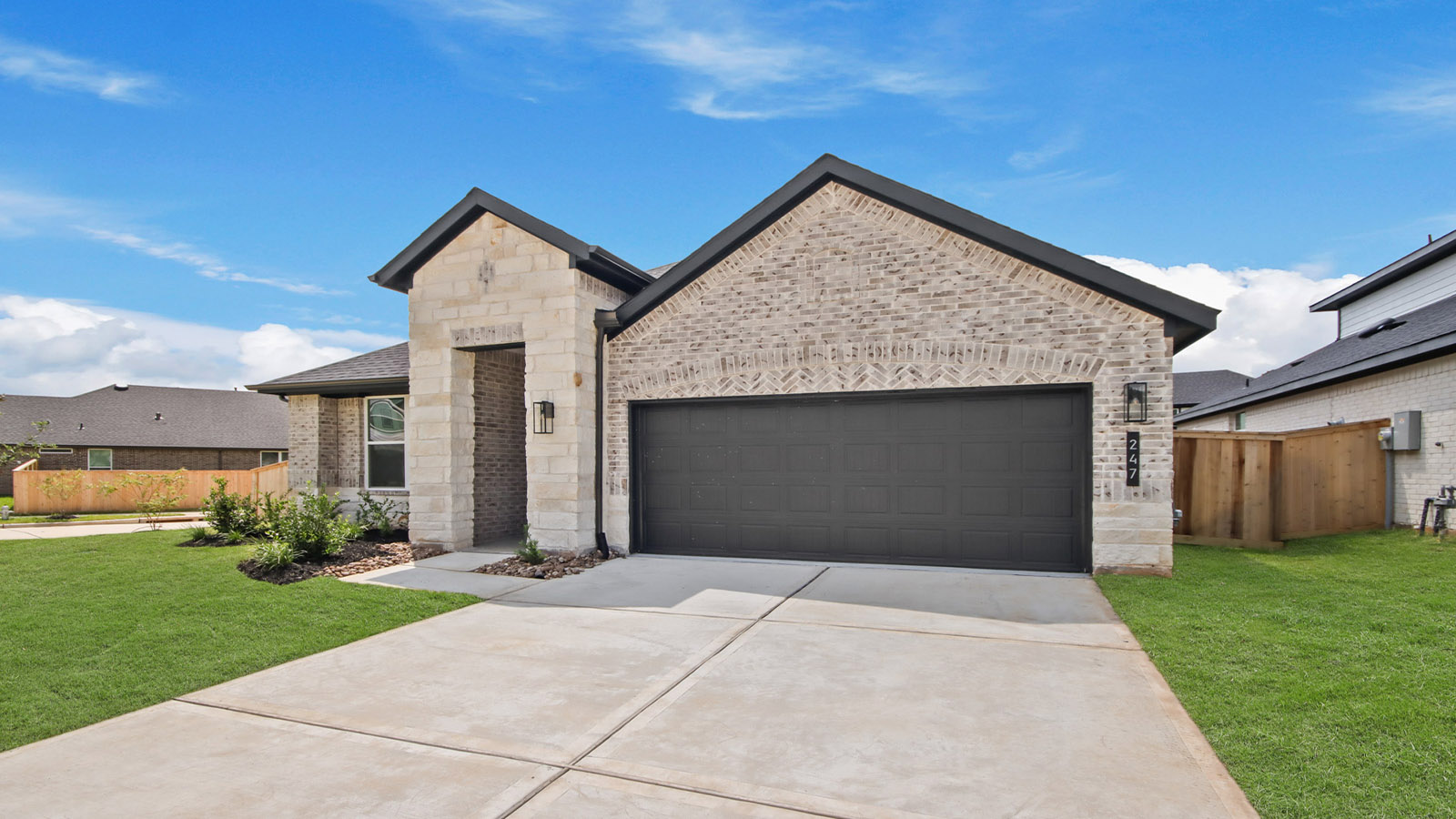 Front of the home with brick.
