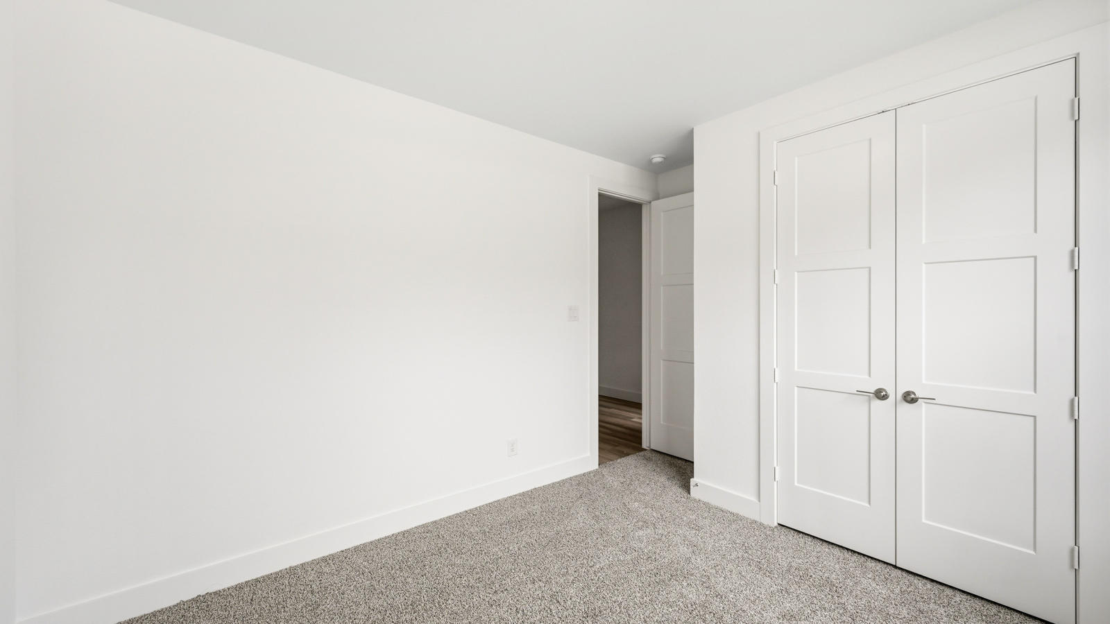 Secondary bedroom with carpet flooring