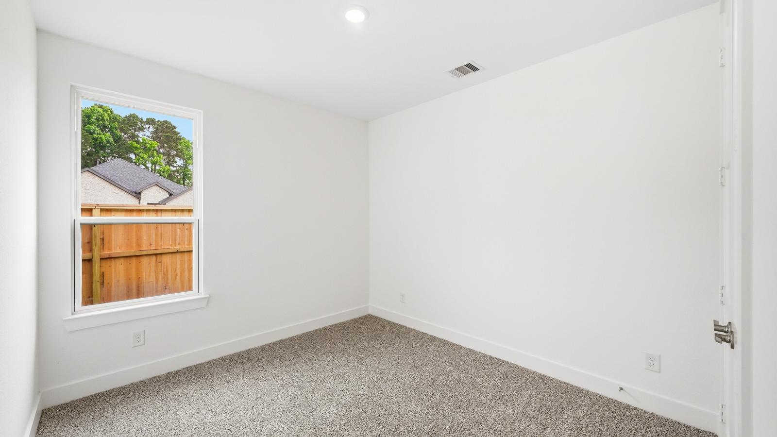 Secondary bedroom with carpet flooring