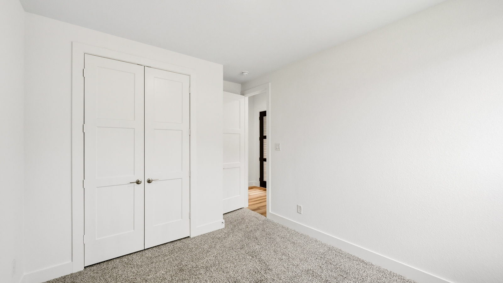 Secondary bedroom with carpet flooring
