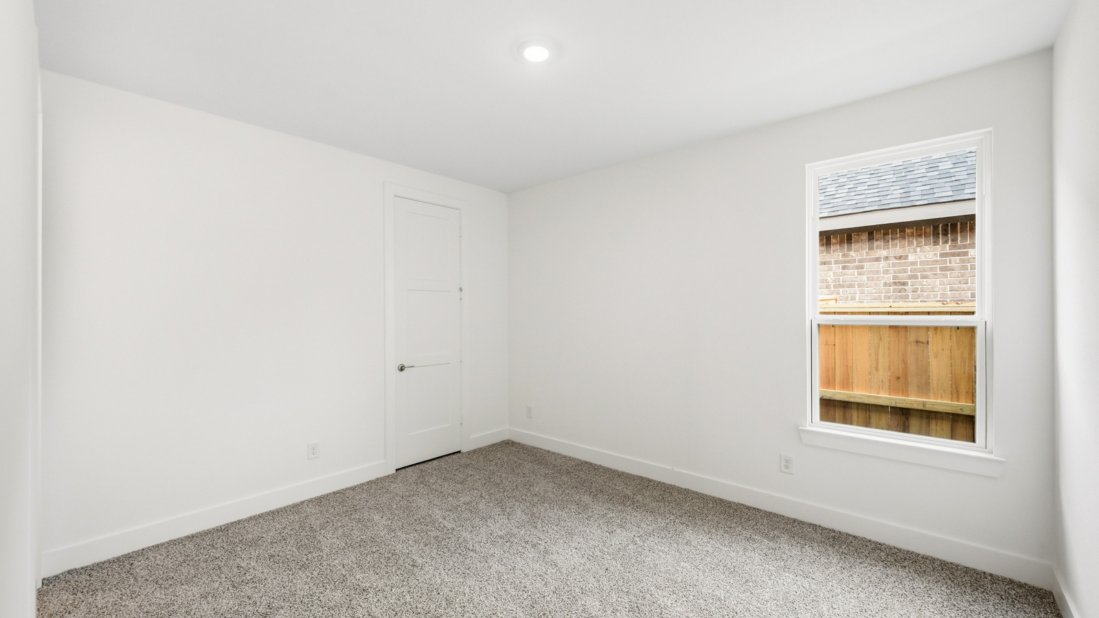 Secondary bedroom with carpet flooring
