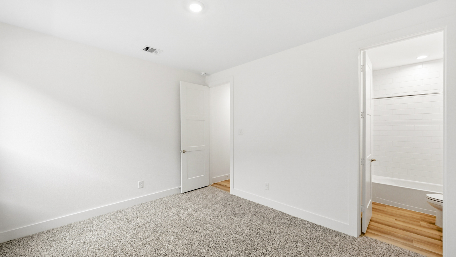 Secondary bedroom with carpet flooring