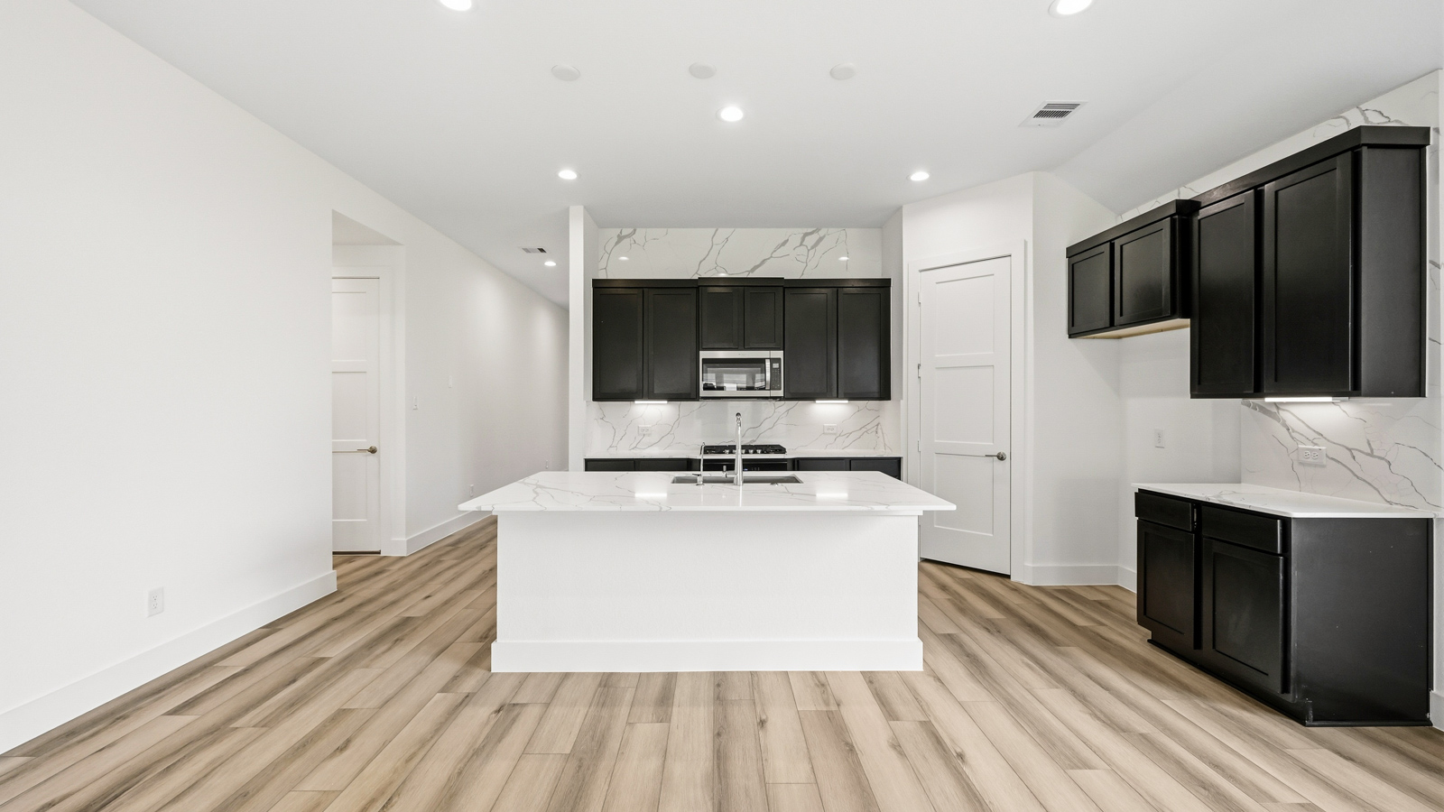 Kitchen with an island and vinyl floor