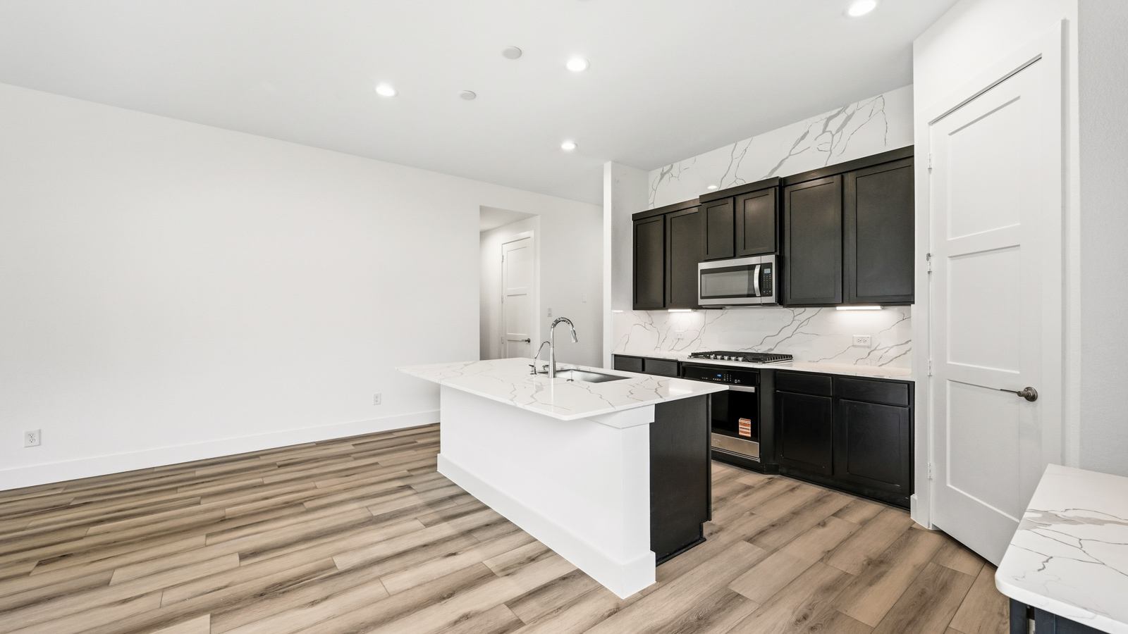 Kitchen with an island and vinyl floor