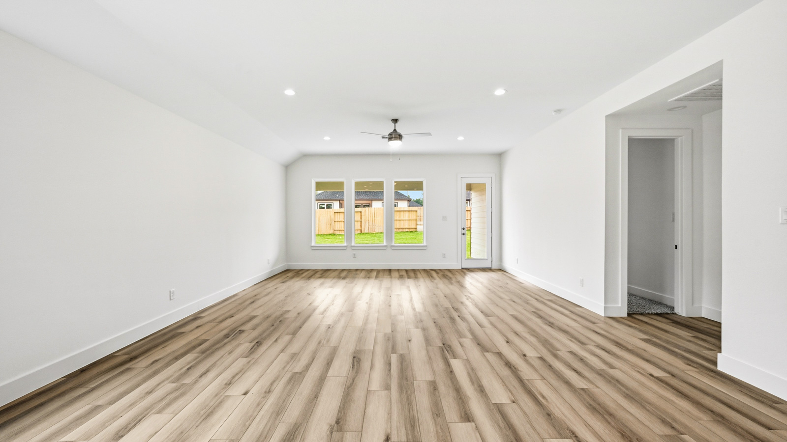 Spacious living area with vinyl flooring