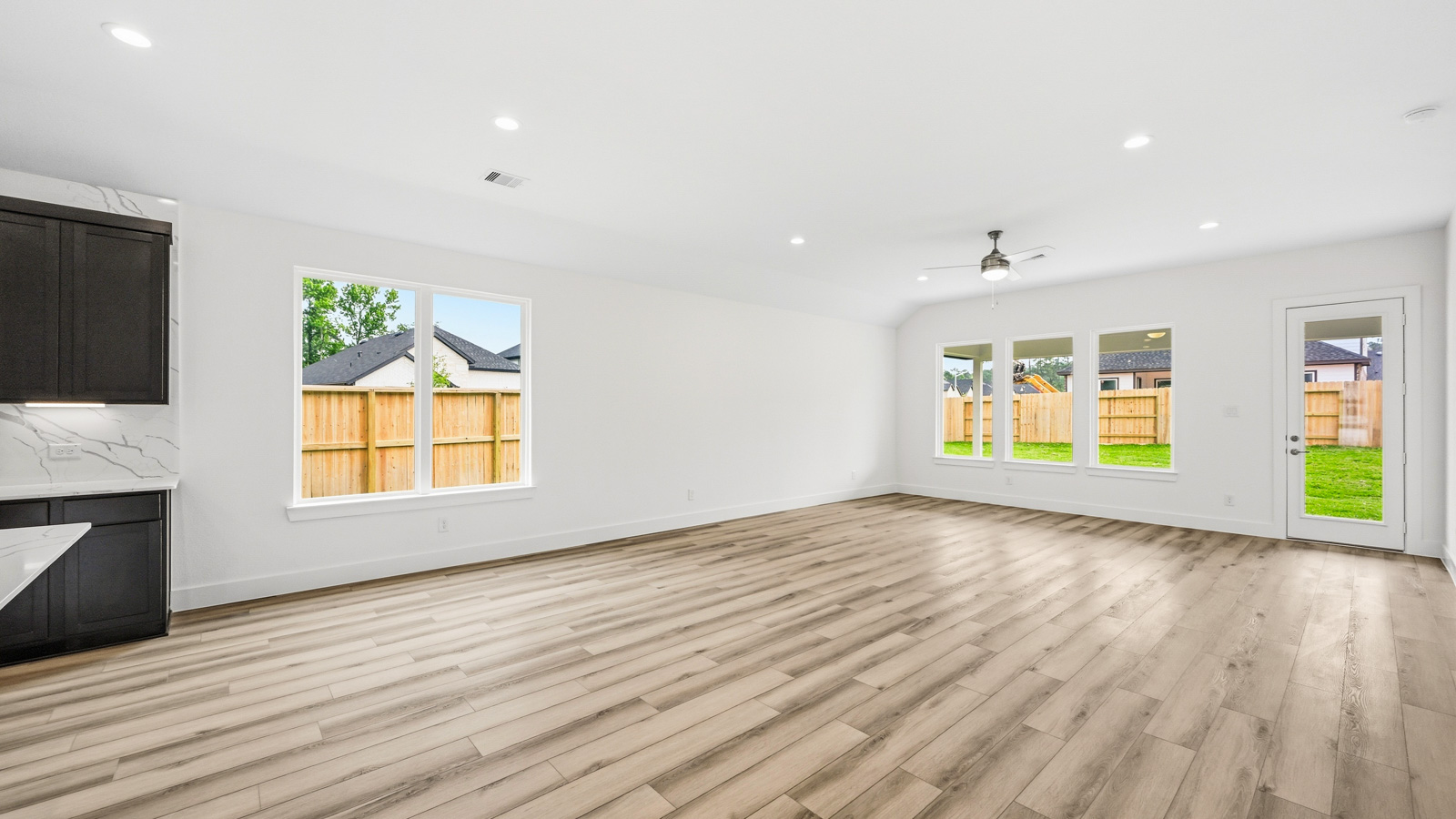 Spacious living area with vinyl flooring