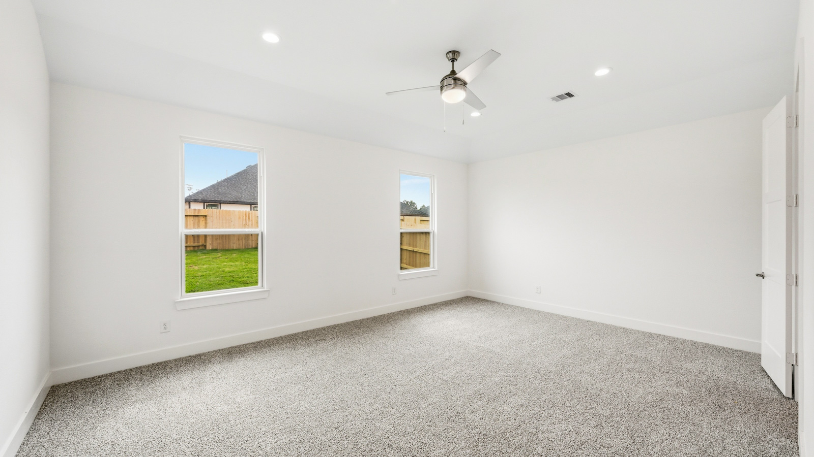 Primary bedroom with carpet flooring