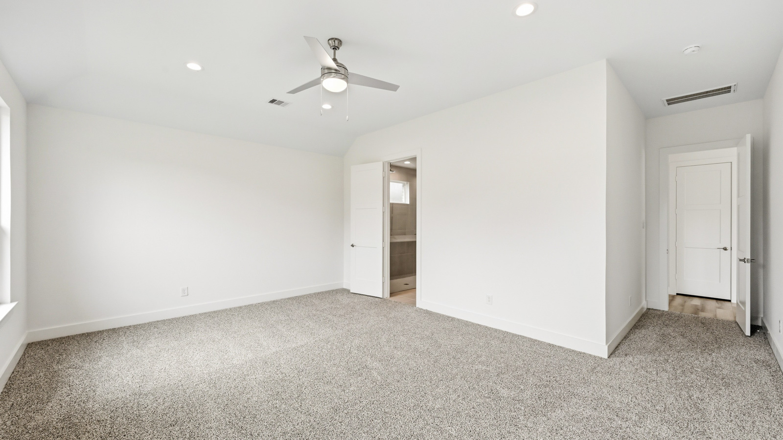 Primary bedroom with carpet flooring