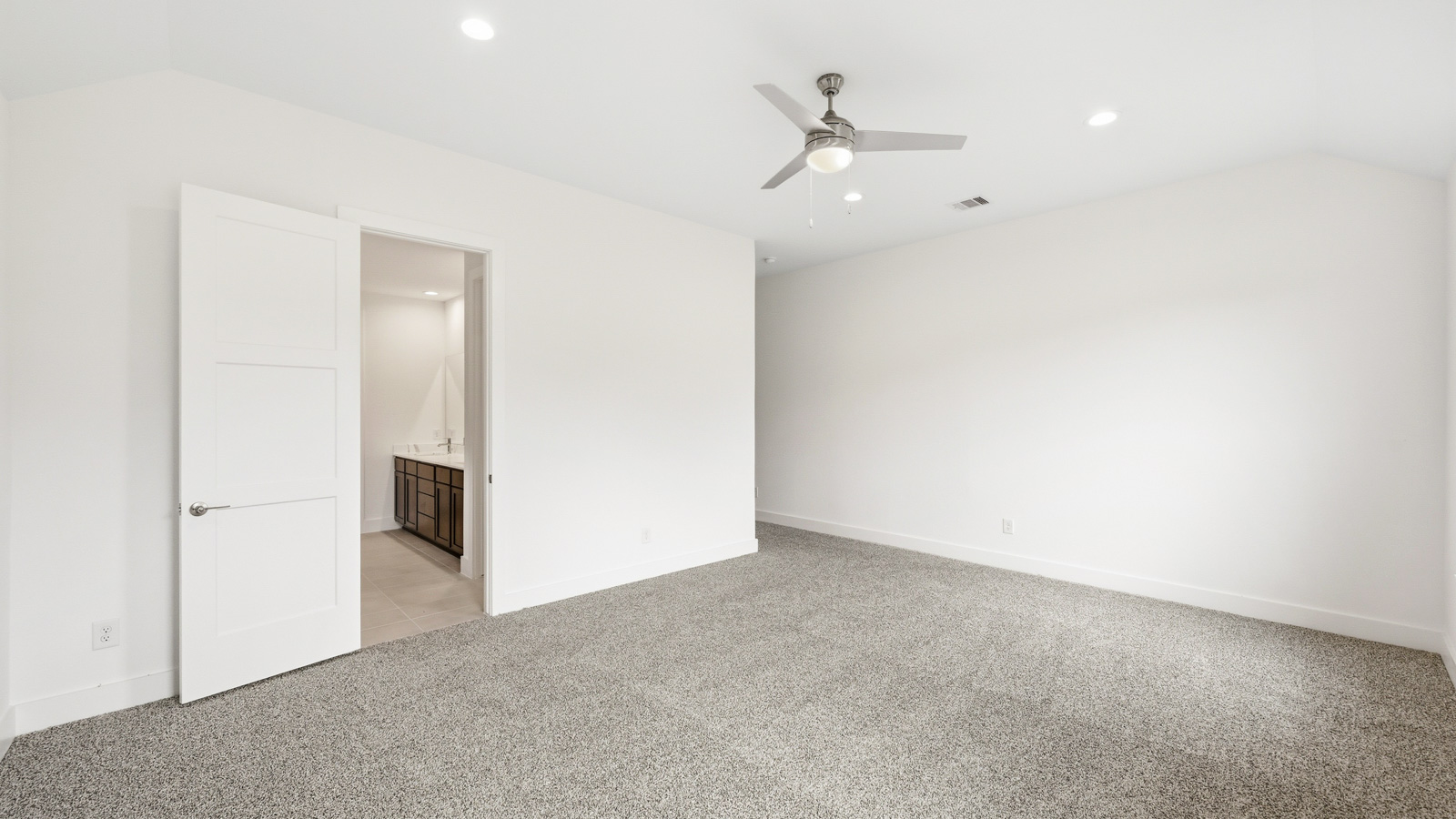 Primary bedroom with carpet flooring
