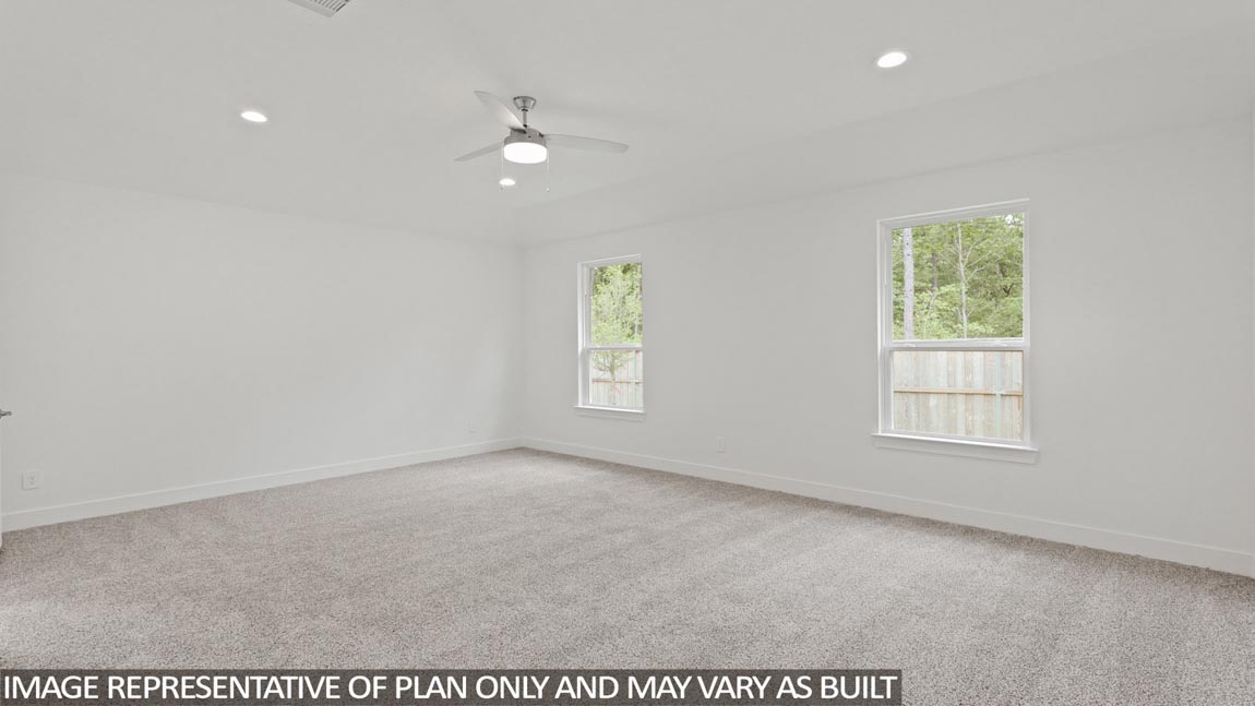 Primary bedroom with carpet flooring