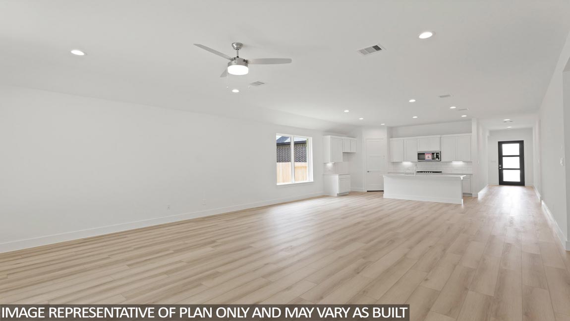 Spacious living area with vinyl flooring