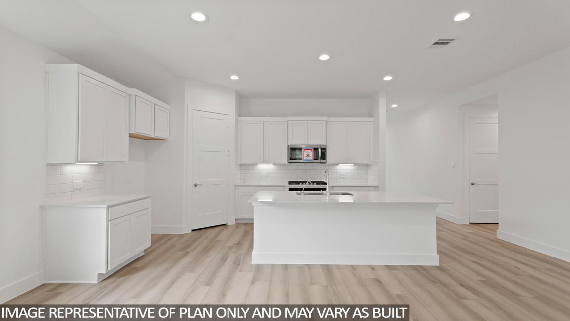Kitchen with an island and vinyl floor