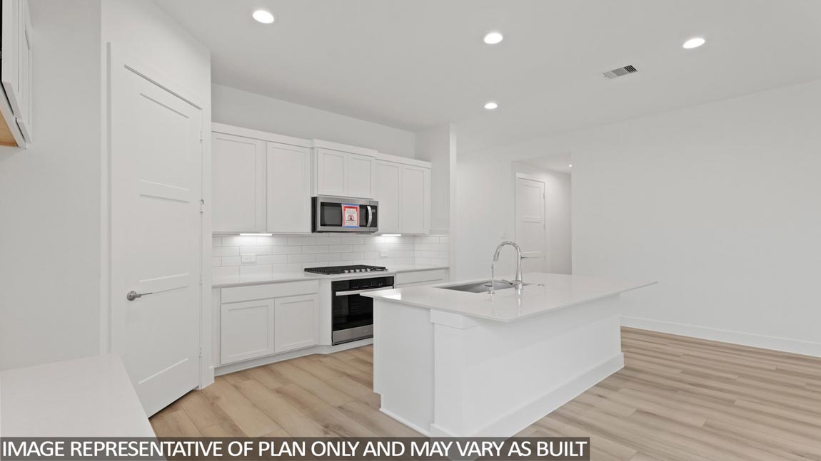 Kitchen with an island and vinyl floor