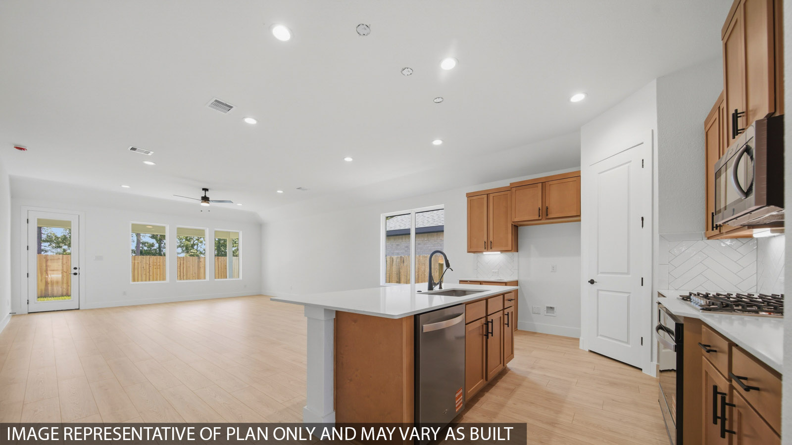 Kitchen with quartz countertops and marden hardware and an island and vinyl floor