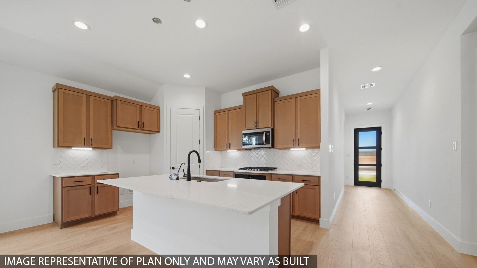 Kitchen with quartz countertops and marden hardware and an island and vinyl floor