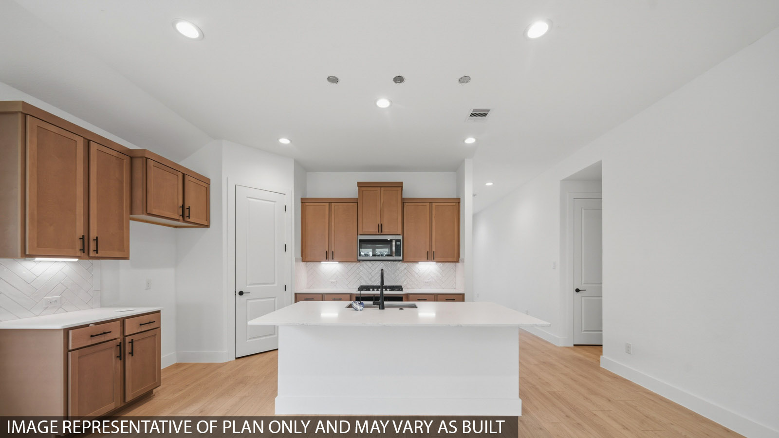 Kitchen with quartz countertops and marden hardware and an island and vinyl floor