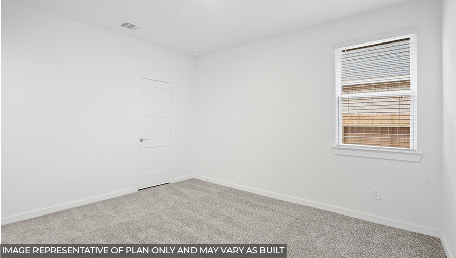 Secondary bedroom with carpet flooring and a bright window.