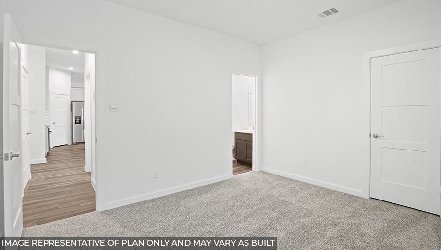 Secondary bedroom with carpet flooring and a tall closet.