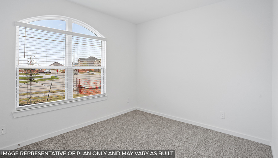 Secondary bedroom with carpet flooring and bright windows.