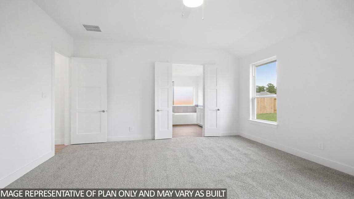 Primary bedroom with carpet flooring