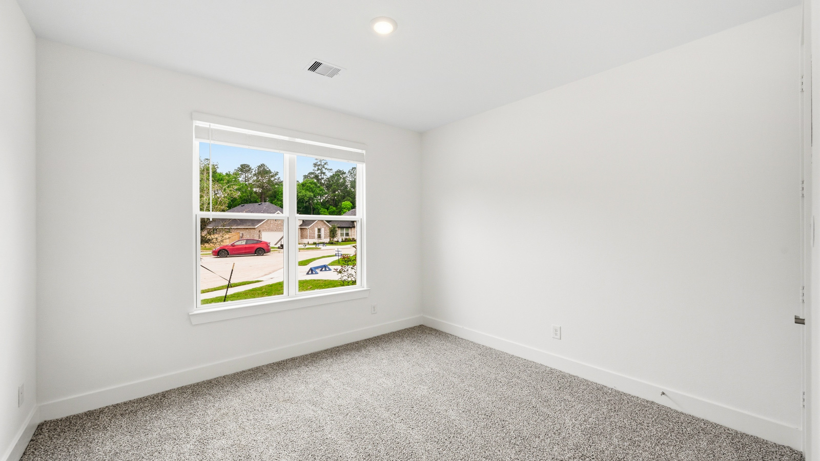 Secondary bedroom with carpet flooring