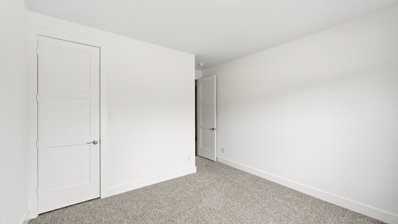 Secondary bedroom with carpet flooring