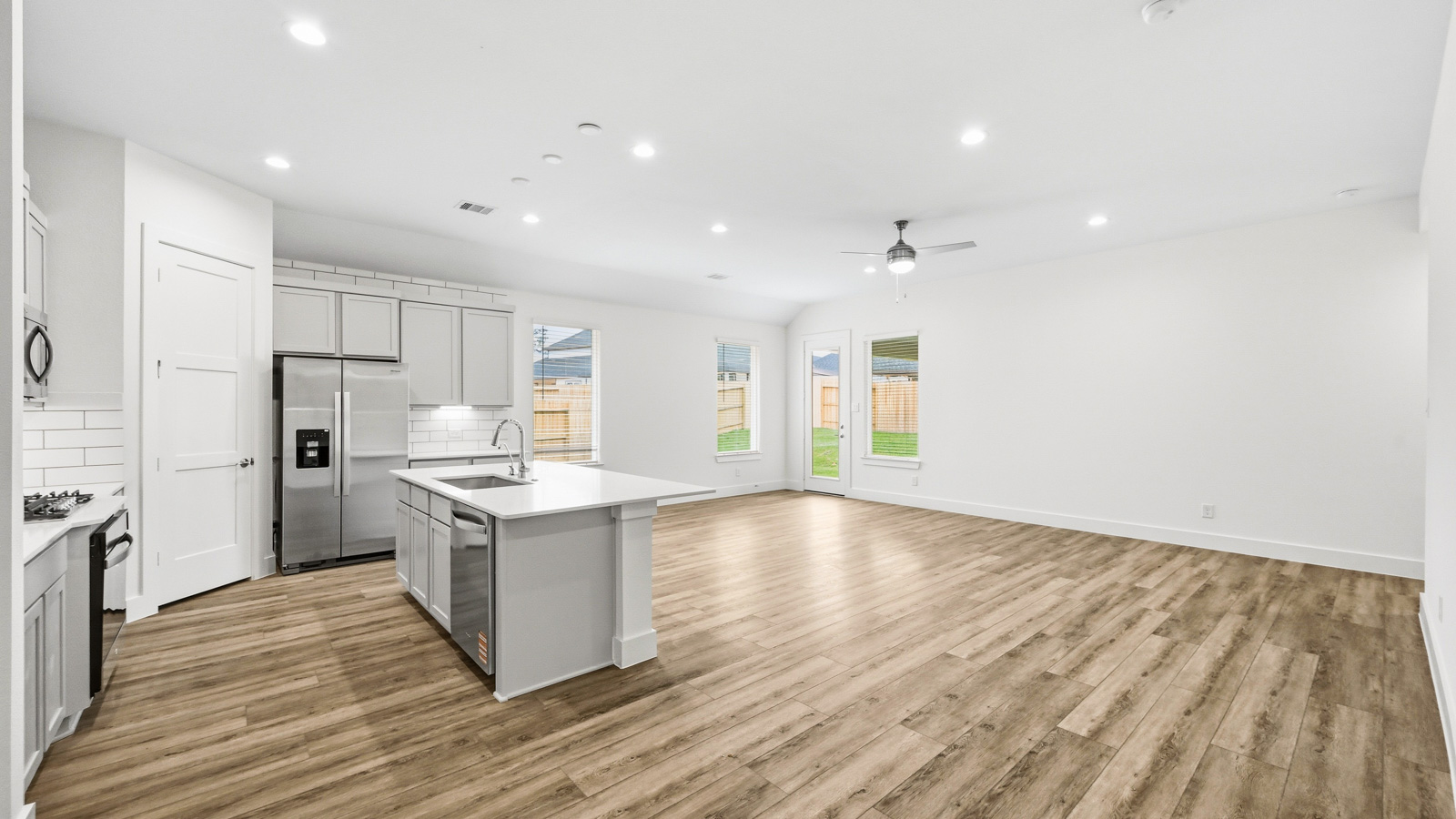 Spacious living area with vinyl flooring