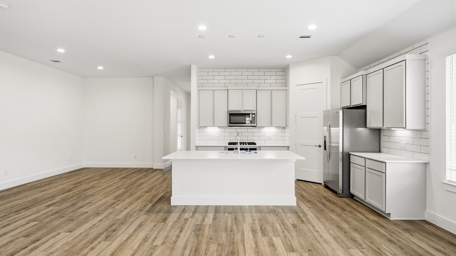 Kitchen with an island and vinyl floor