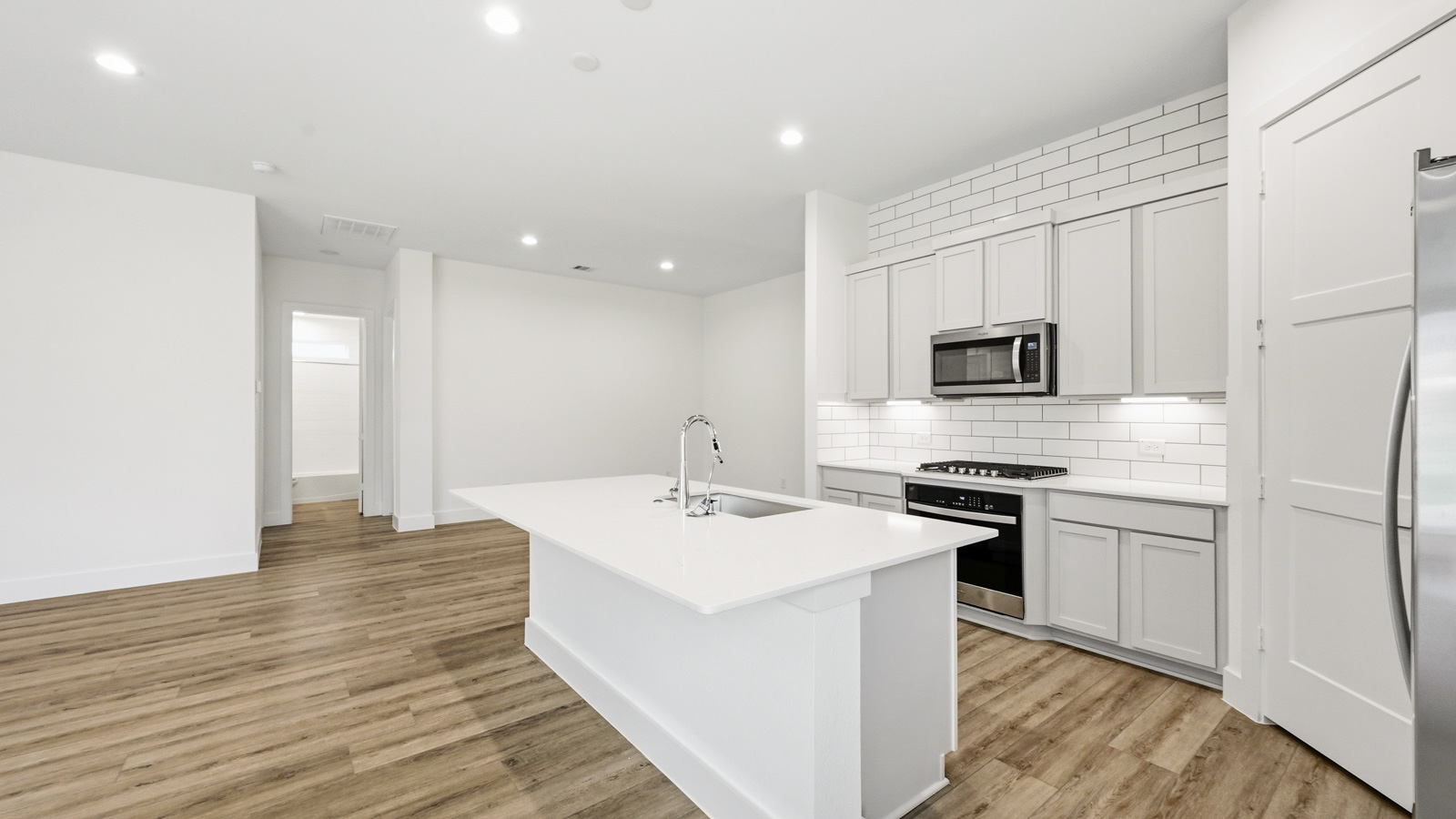 Kitchen with an island and vinyl floor