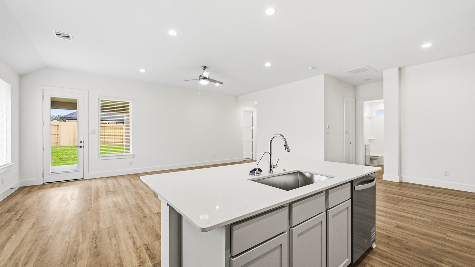 Spacious living area with vinyl flooring